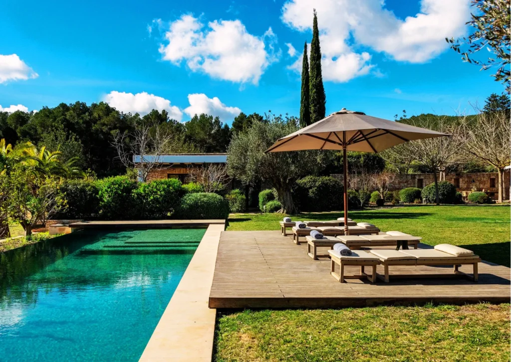 Private swimming pool and Mediterranean gardens at Escape Elegant country estate in Ibiza.